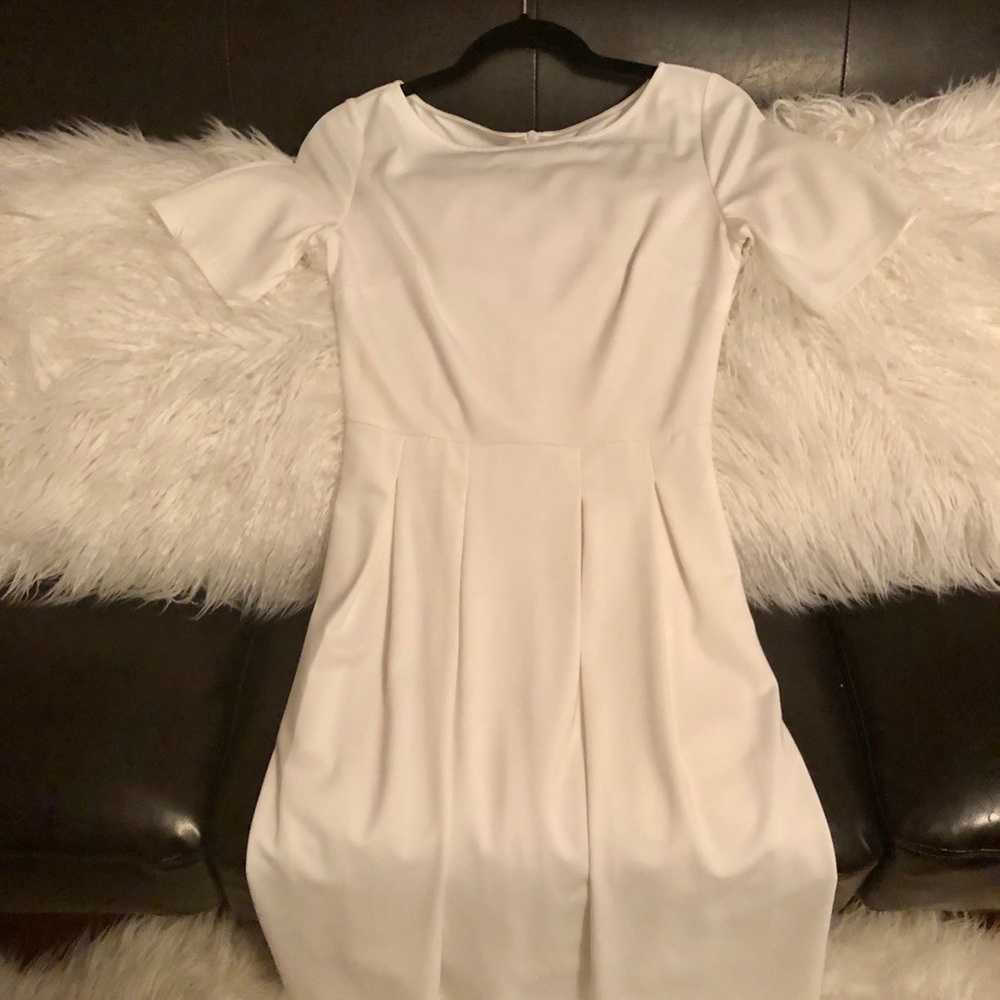White pleated dress. Short sleeves.